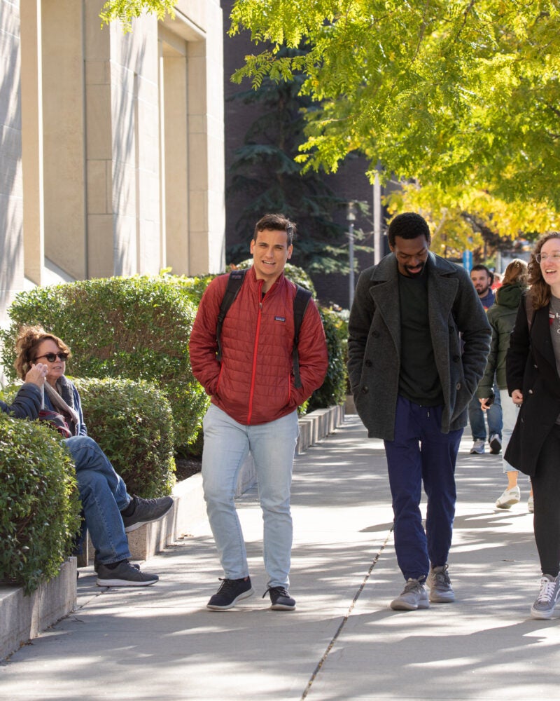 Students walking on campus in the fall