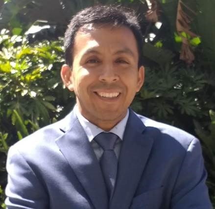 Headshot of Juan-Andres Fuentes standing in front of trees.