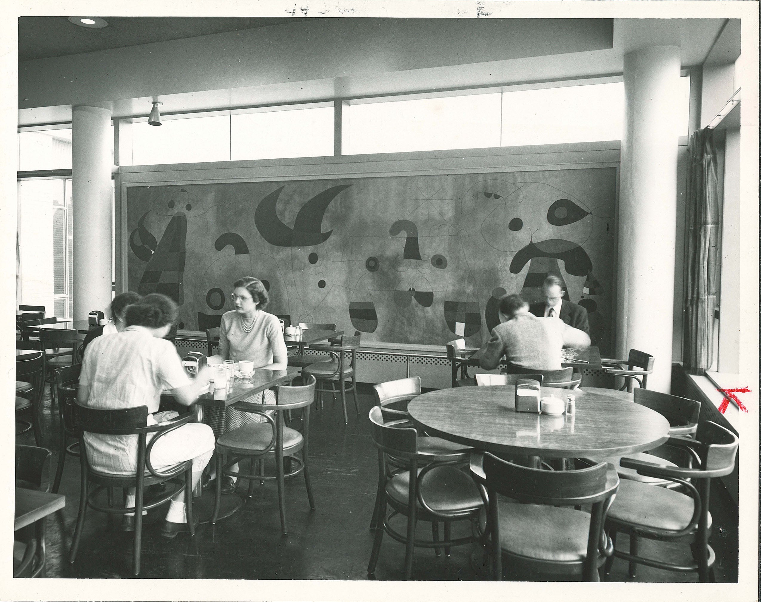 Women and men eating in the dining hall in the 1950s.